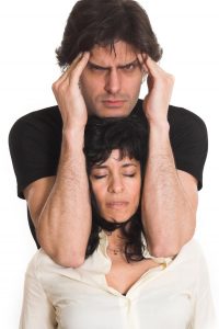 Portrait of couple with woman eyes closed and man with migraine